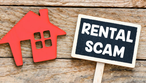 RENTAL SCAM text written on a chalk board.