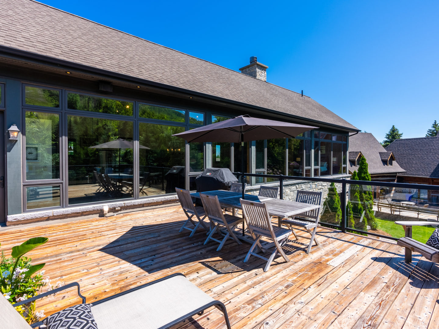 A large second-story deck with outdoor dining space.