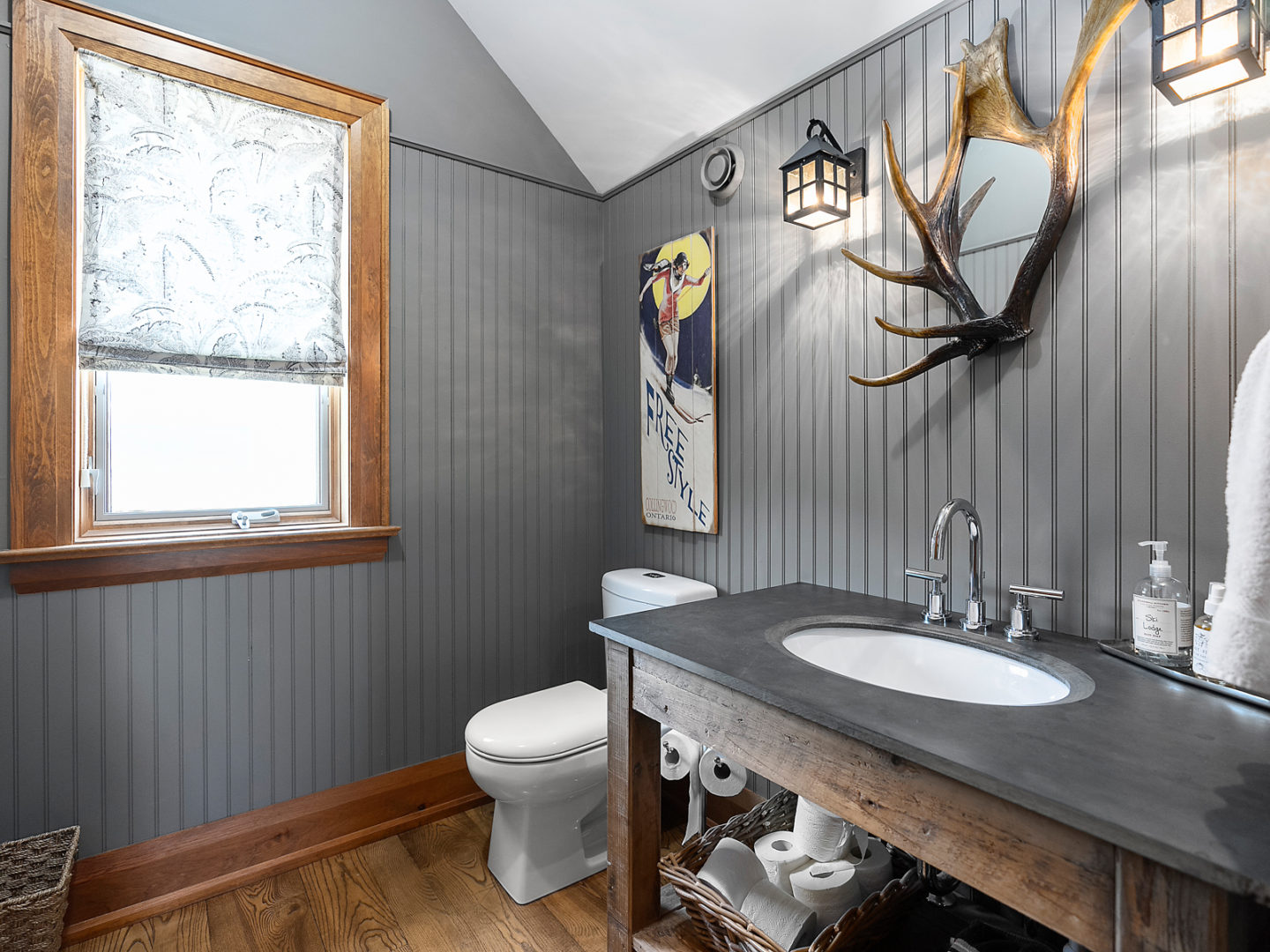 A small powder room with a toilet and a sink.