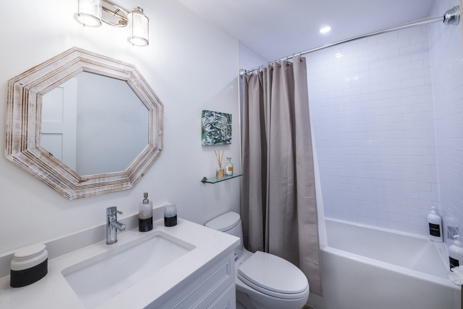A small bathroom with a toilet, a sink, and a shower-bathtub combo.