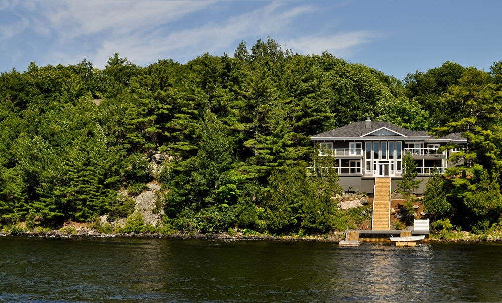 Cottage with a staircase to the dock on a lake