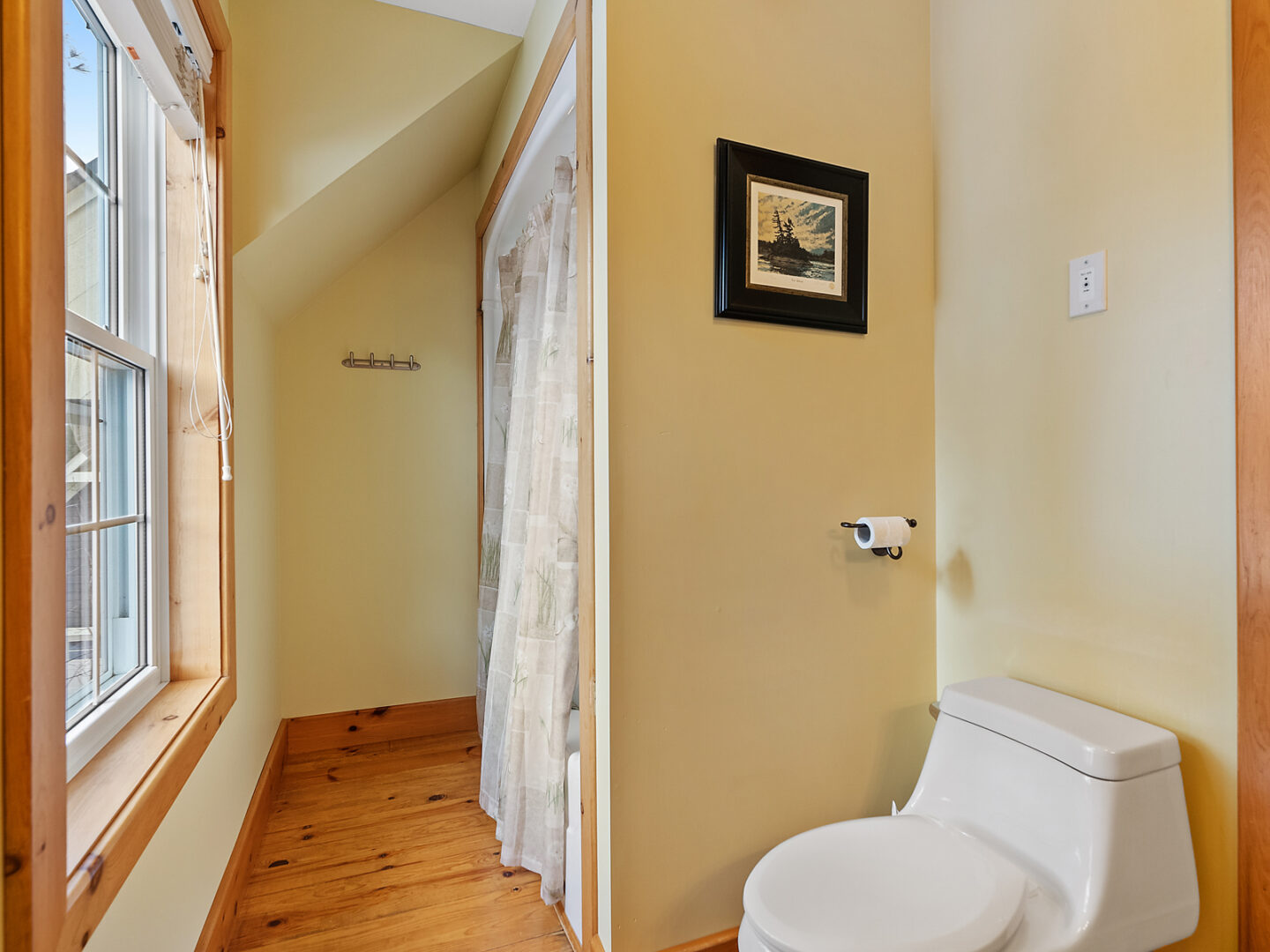 A small bathroom with a toilet and a shower/tub combo.