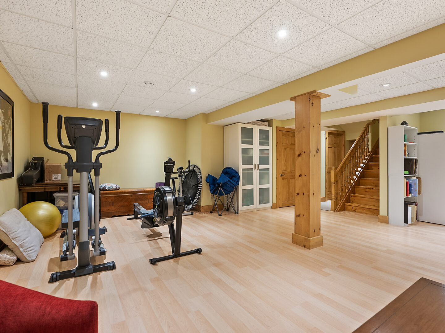 A spacious basement area with exercise equipment.