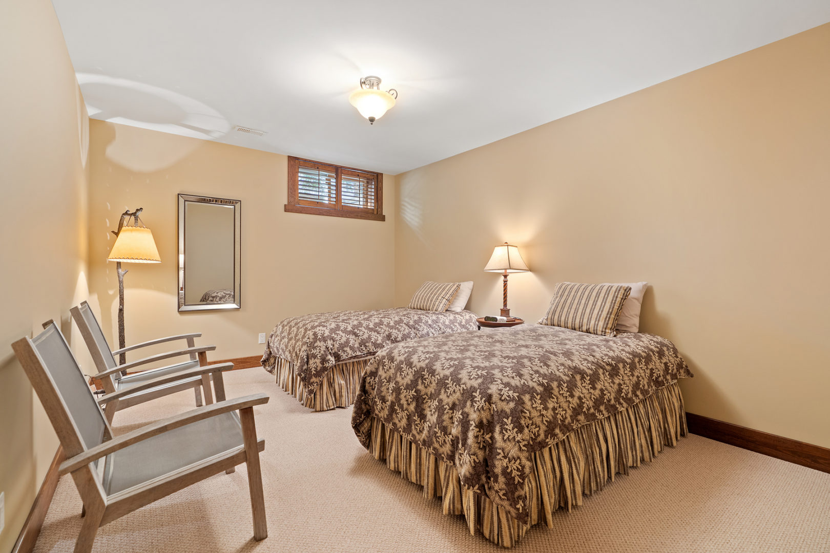 A basement bedroom with two small beds.