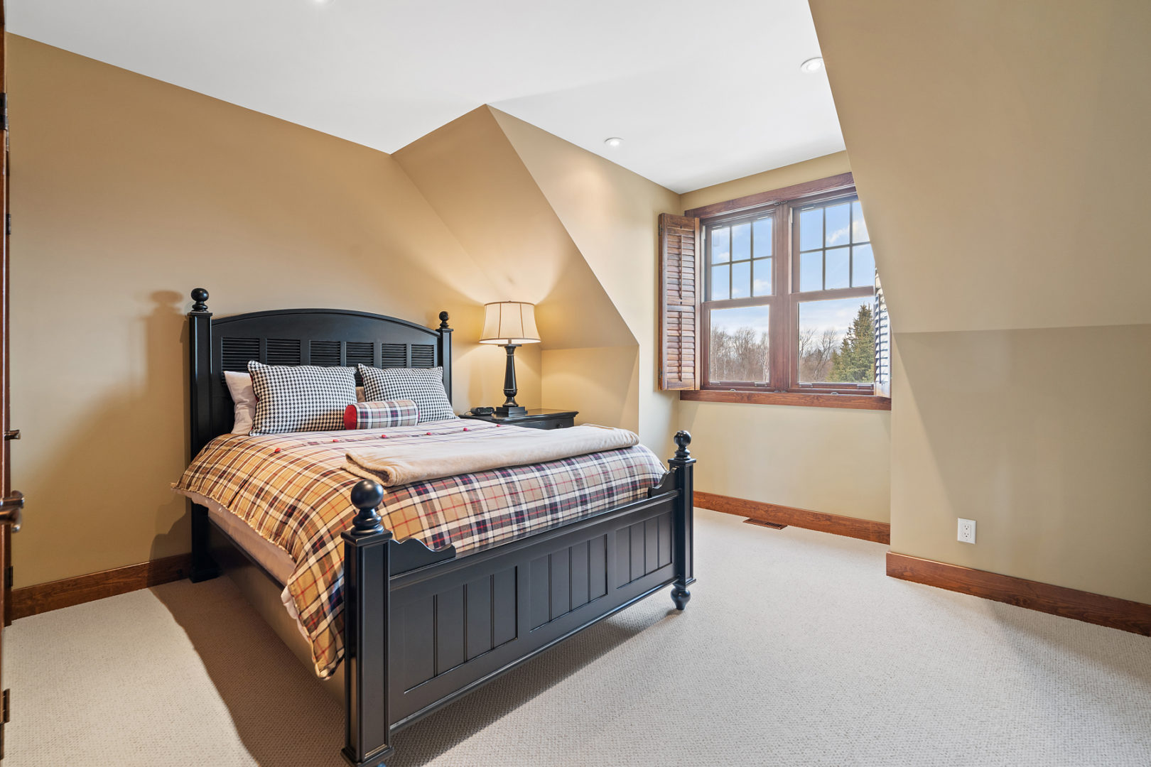 A bright bedroom with a large bed.