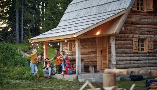 a group of friends on the porch of a cottage