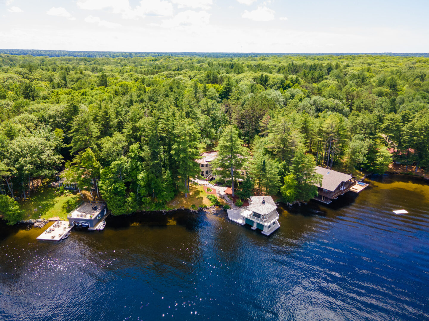 A stretch of shoreline on a lake, with large cottages lining the shore.