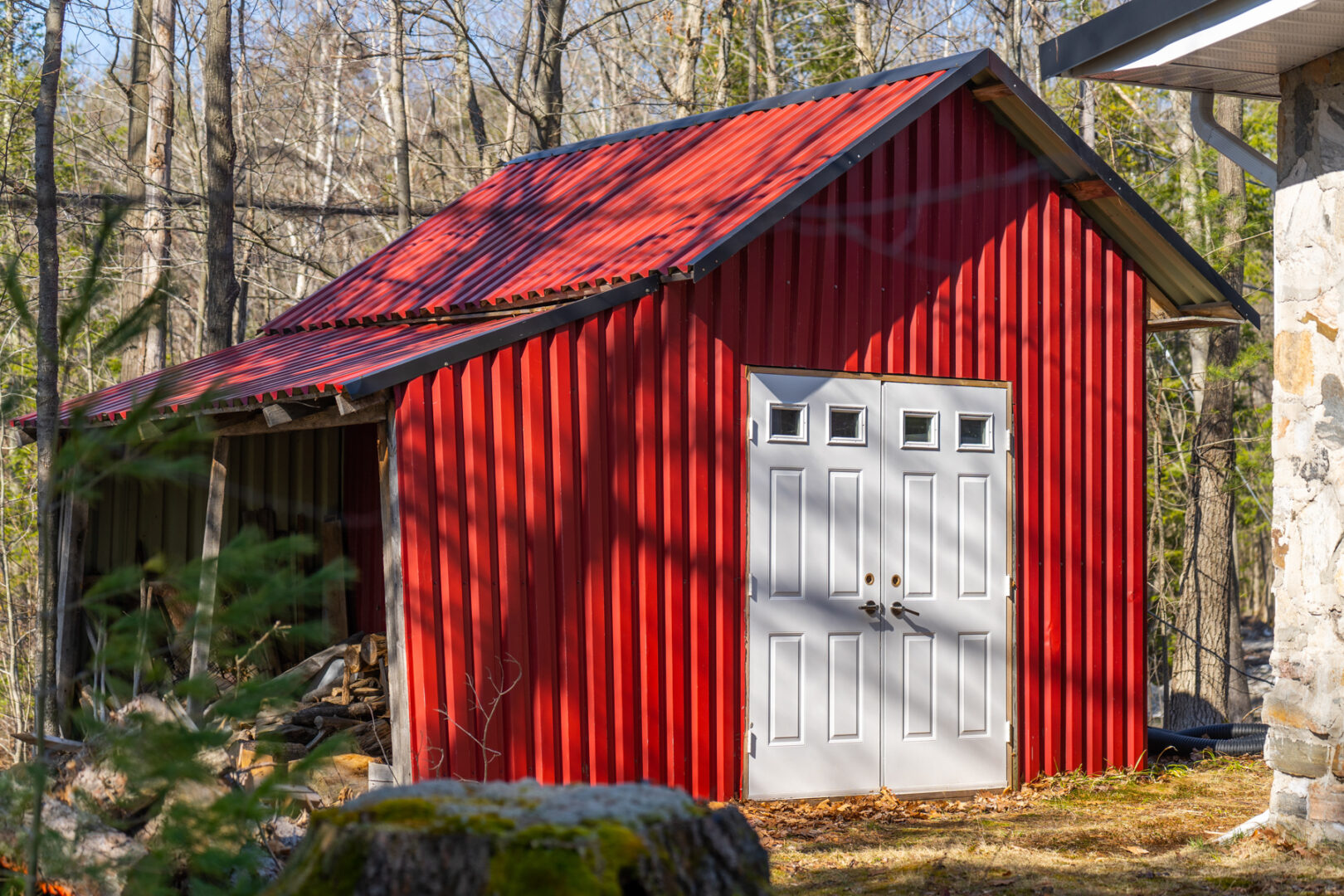 A large red shed with a white door.