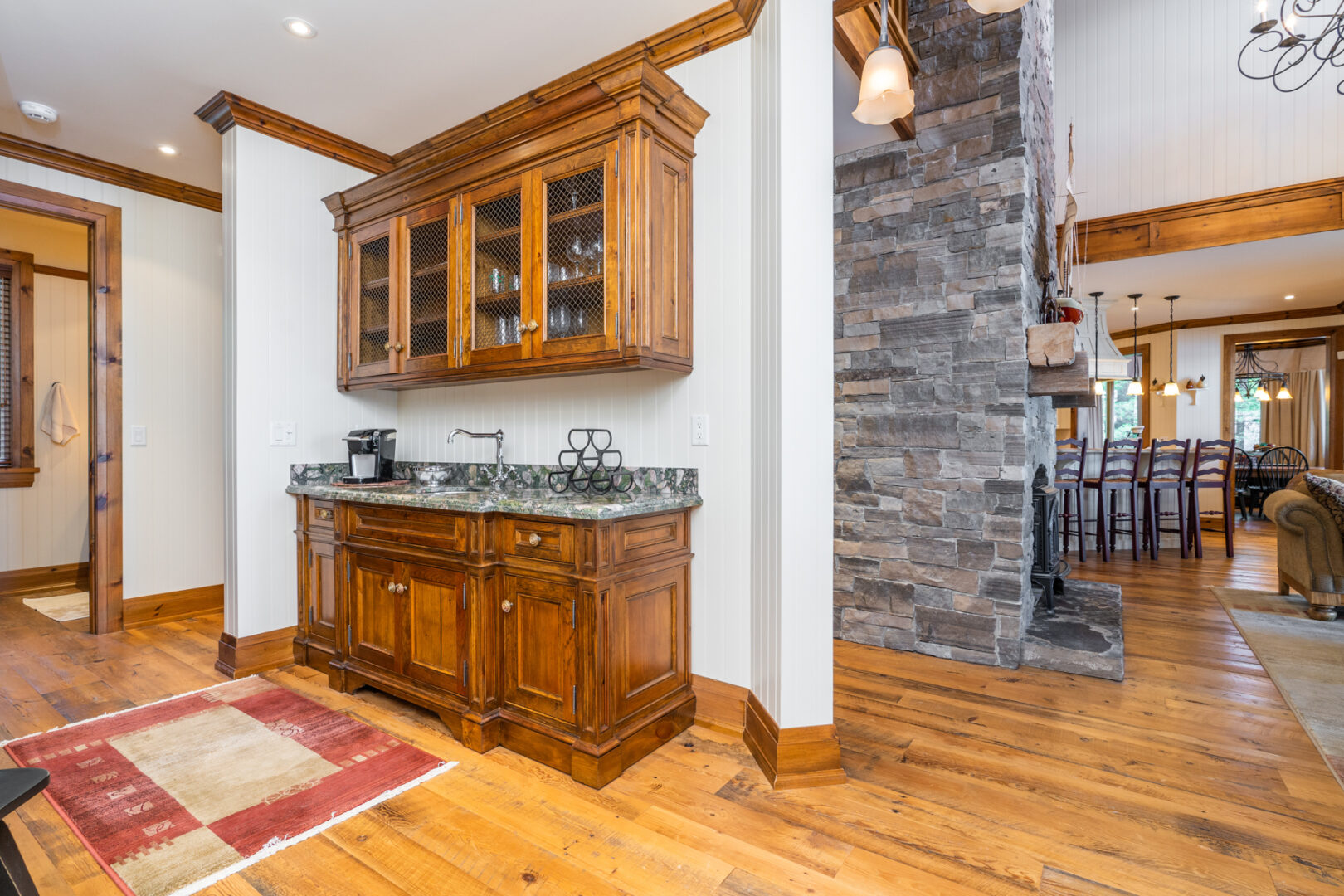 A small sink and cupboard nook in an open-concept living area.