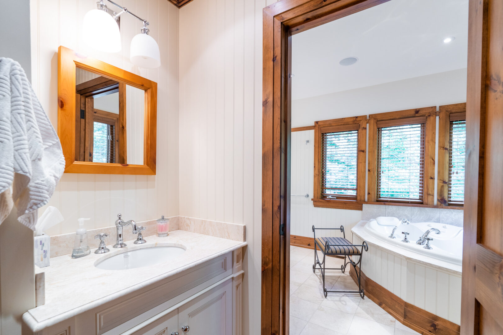 A large ensuite bathroom with a sink and a tub.
