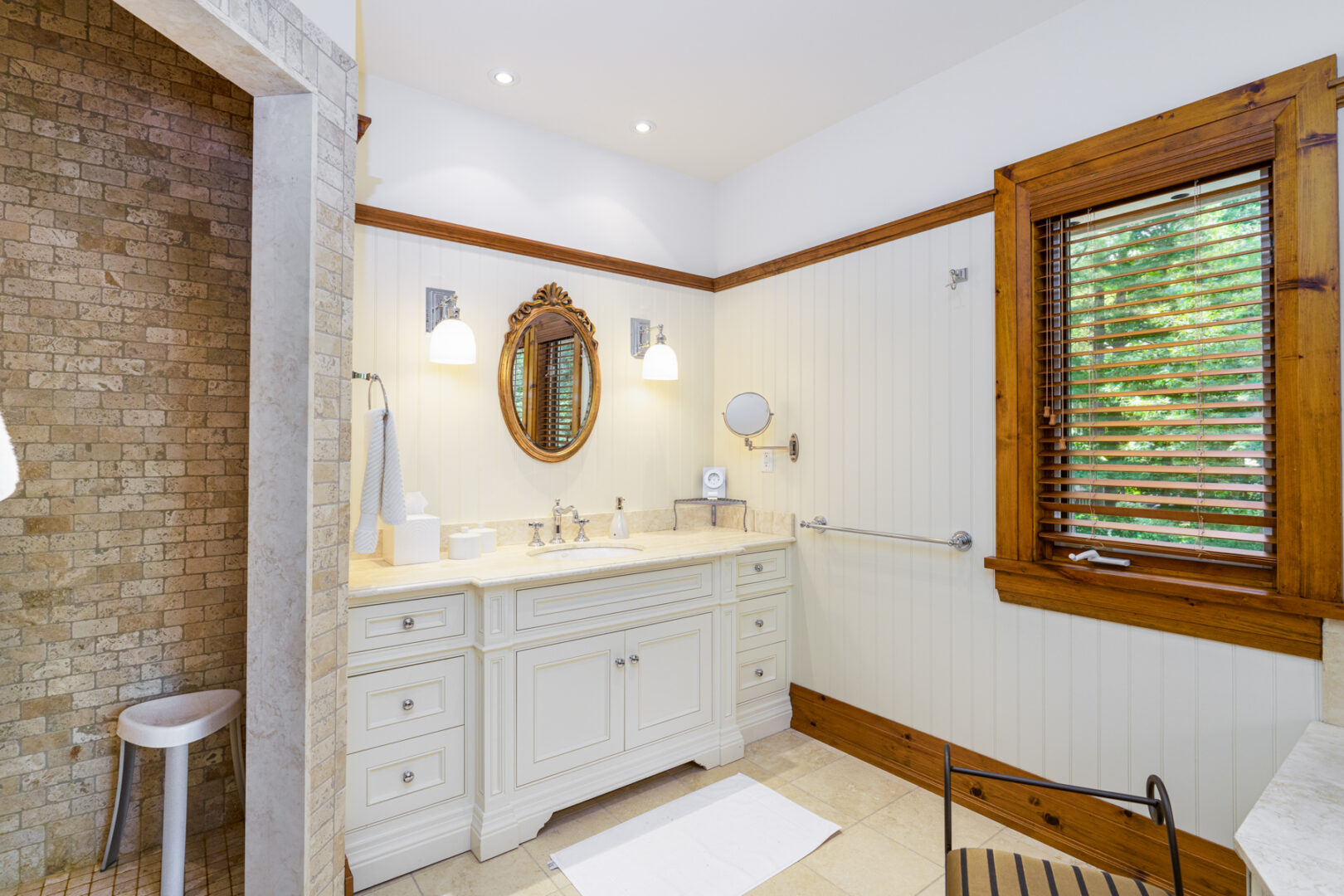 A large ensuite bathroom with a sink and a shower.