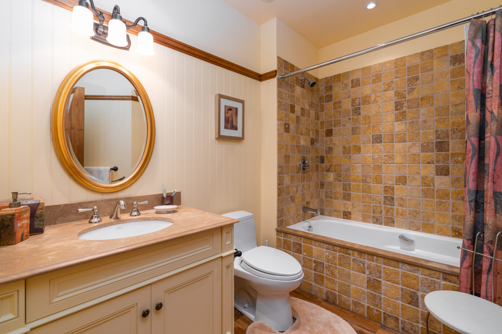 A small bathroom with a toilet, a sink, and a shower/tub combo.