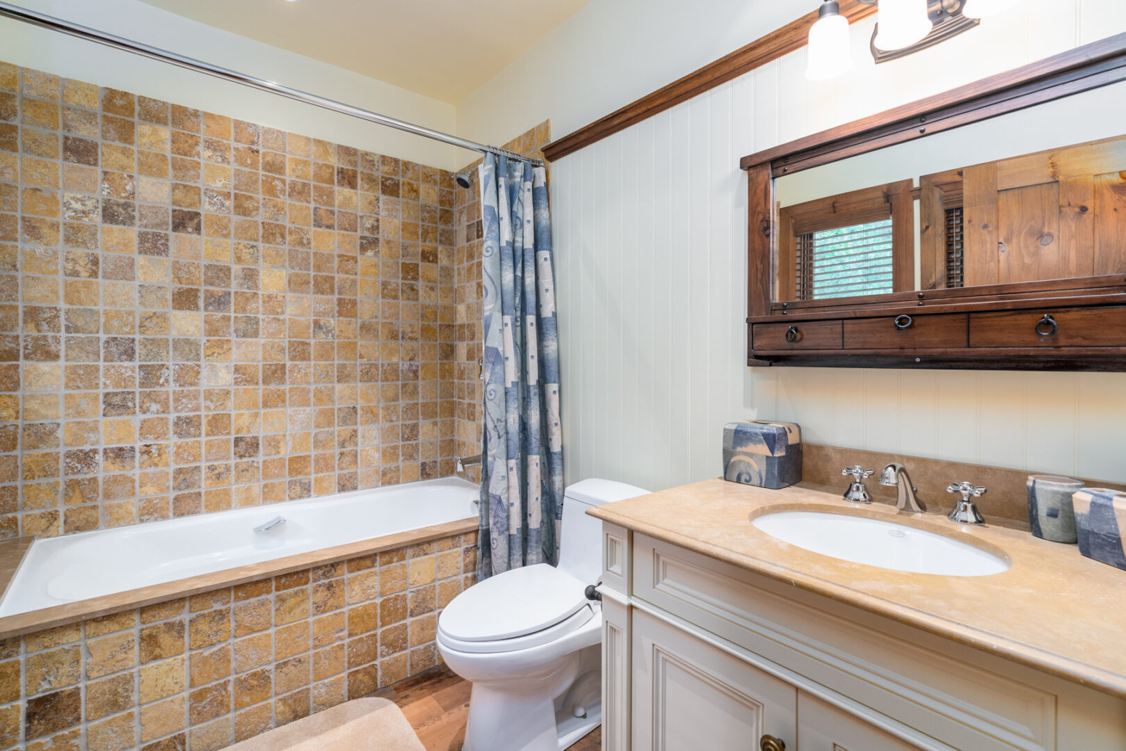 A small bathroom with a toilet, a sink, and a shower/tub combo.