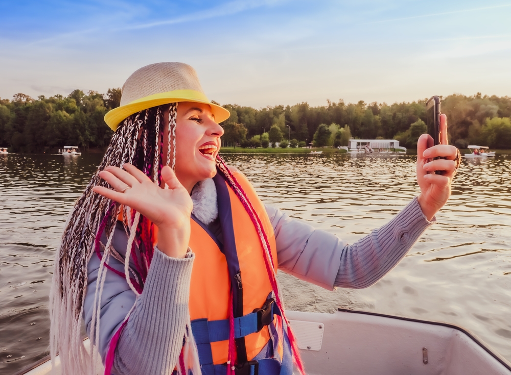 woman on boat taking a selfie