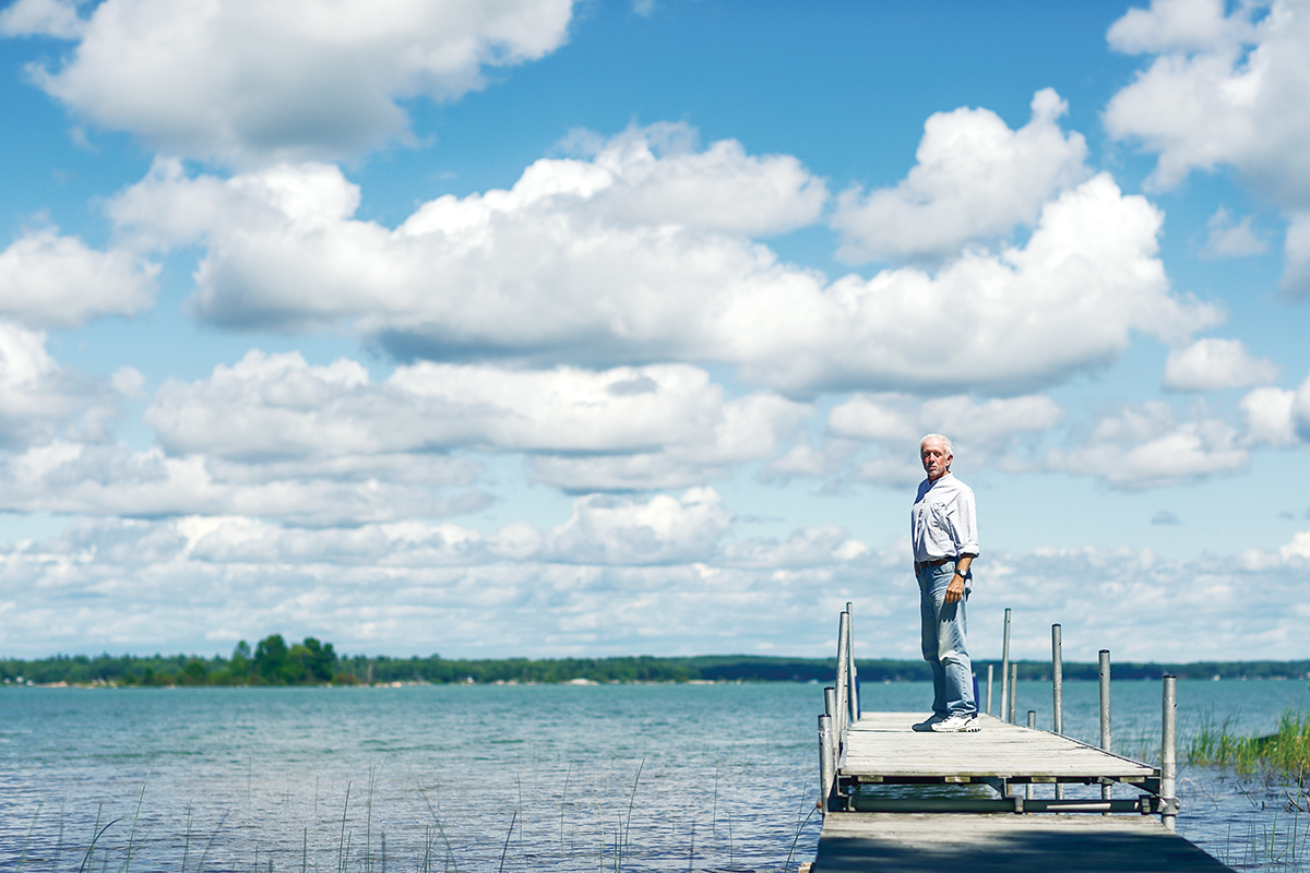 Albert stands on dock on a partly cloudy day