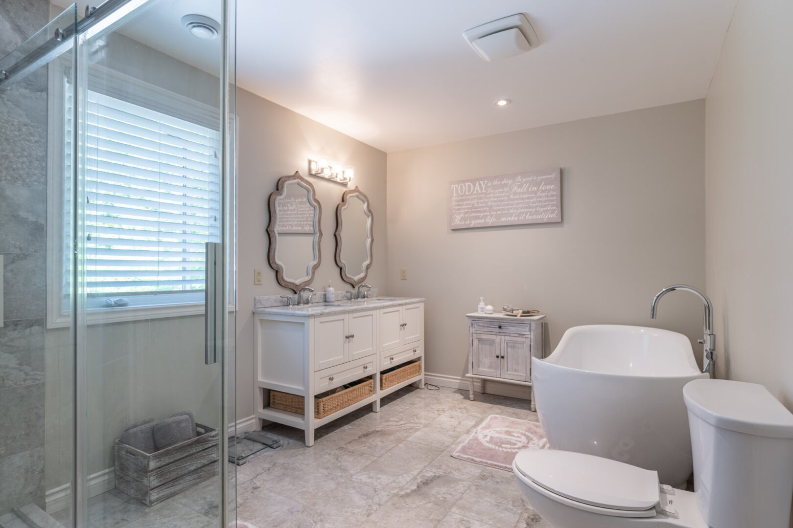 A large ensuite bathroom with a walk-in shower, a toilet, and a sink.
