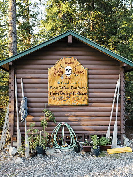 sign on outside of bunkie reading "Jolly Dumm Lodge - rooms for rent, boat rentals, fishing charters, bar, beach, happy hour 5 o'clock daily