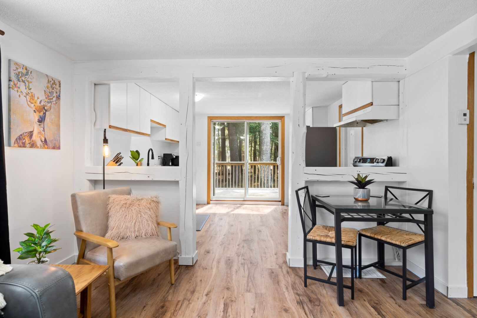 A small dining area with a table and two chairs sits next to the kitchen entryway.