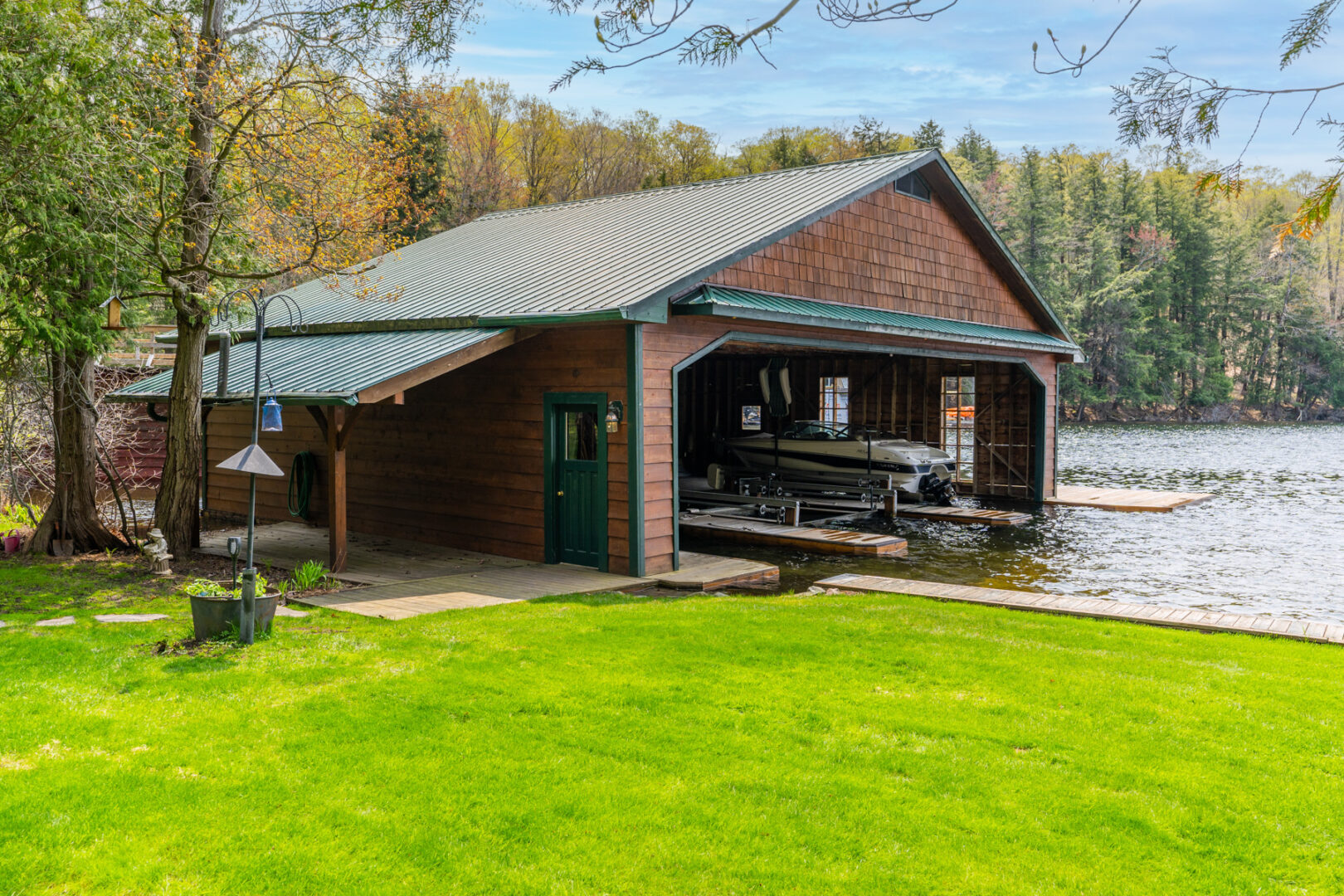 A large boathouse with a small float plane inside.