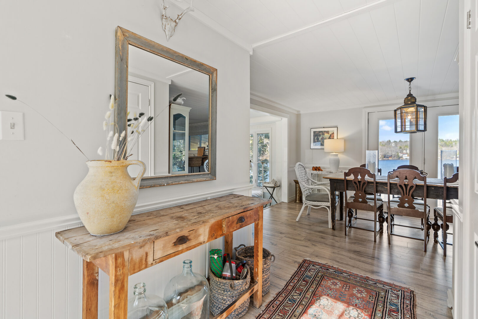 A wide hallway leading from the entrance of a cottage to the open-concept living space.