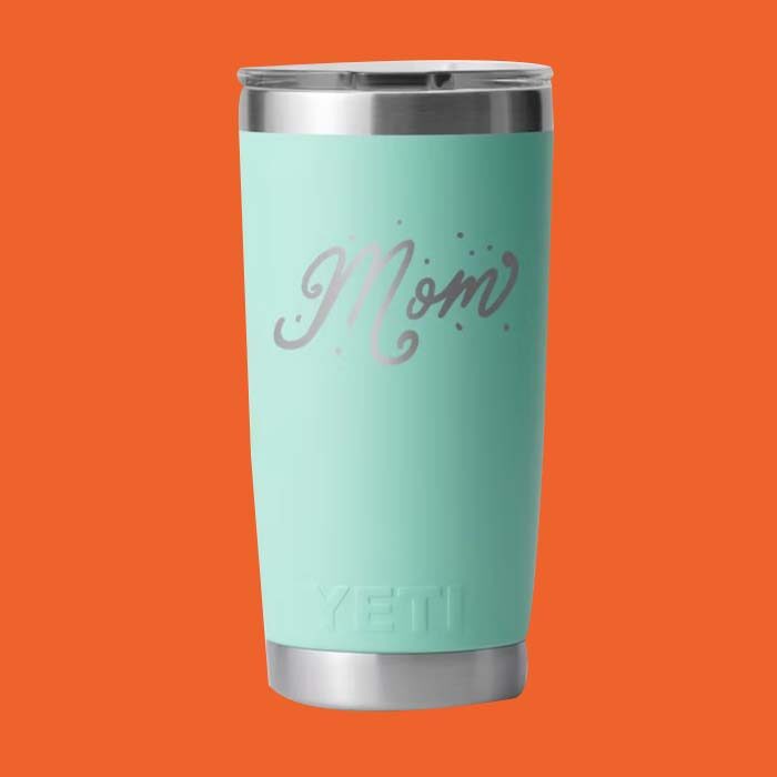 Turquoise drink tumbler with the word mom on it