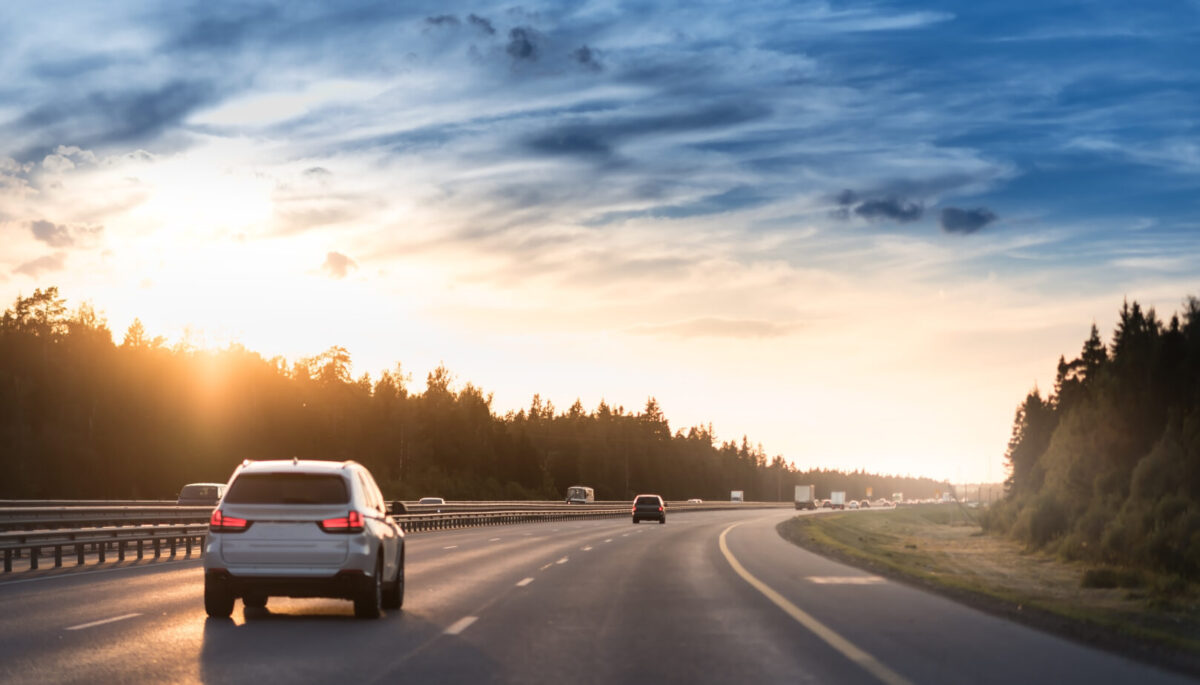 car driving on highway at sunset