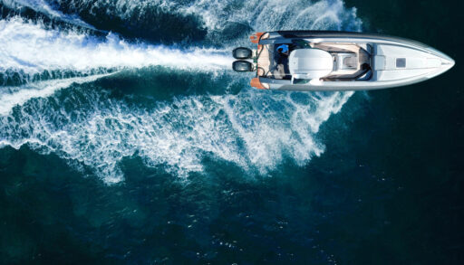 an overhead shot of a motorboat going across a waterbody, boat noise