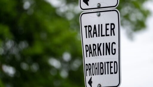 Close-up of a metal sign that says "Trailer Parking Prohibited".