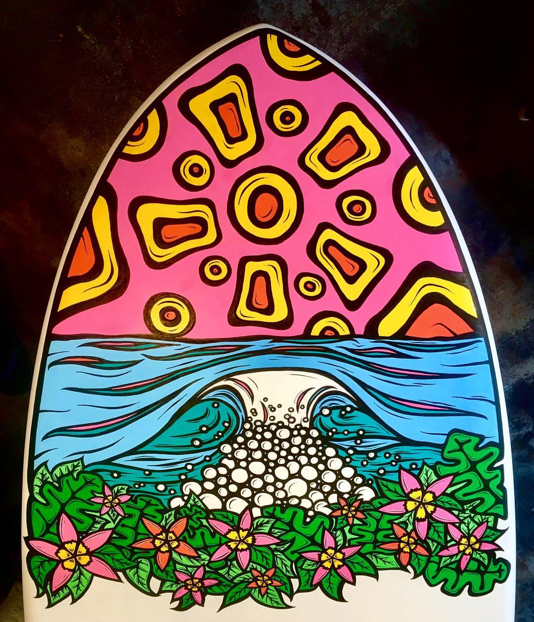 funky sunset over water and flowers on a paddleboard