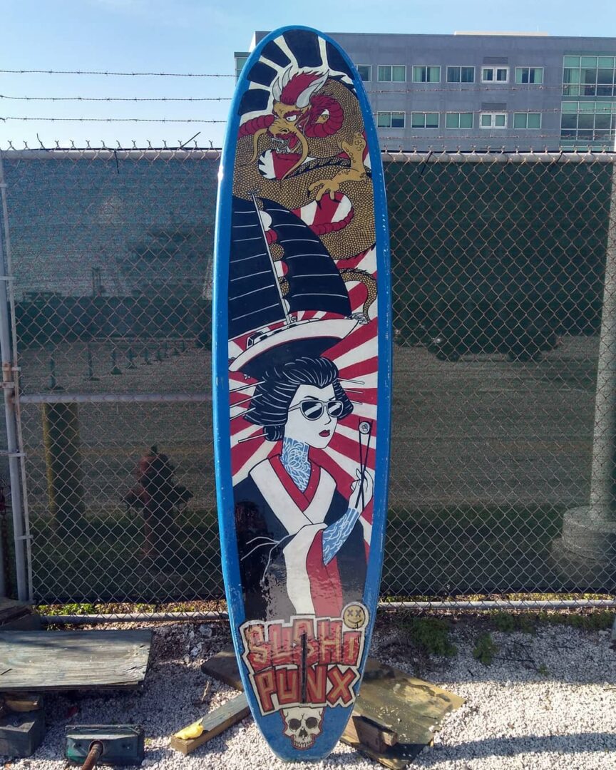 sushi inspired paddleboard with japanese woman eating sushi