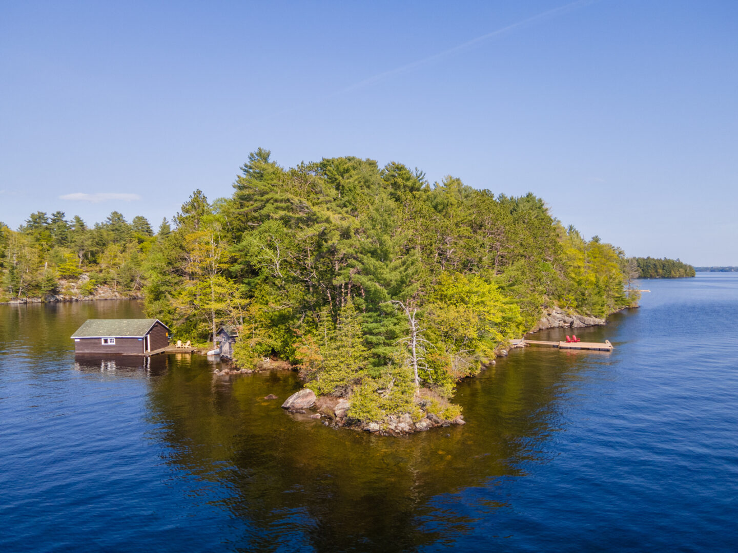 The point of an angular peninsula on a lake island, surrounded by deep blue lake.