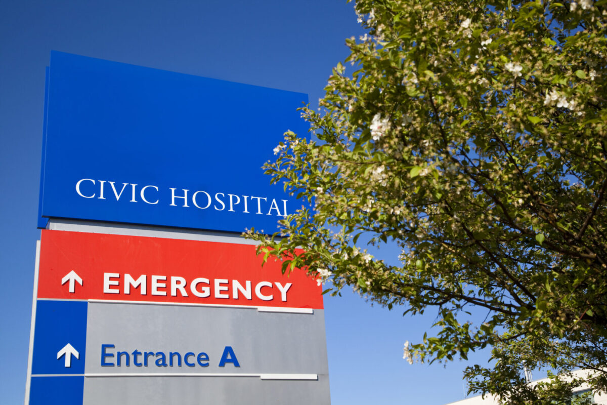 Sign for Civic Hospital Emergency Centre behind a tree