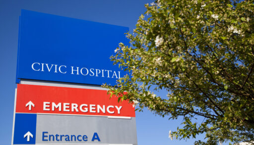 Sign for Civic Hospital Emergency Centre behind a tree