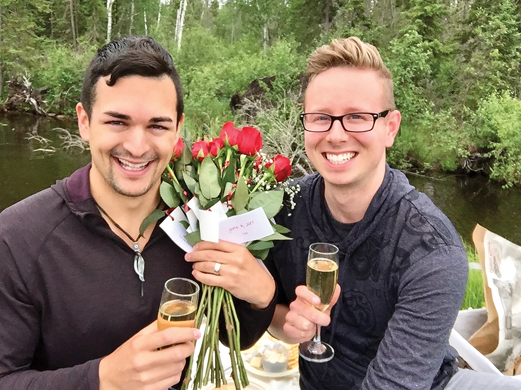 Damon and Kendell smile with flowers