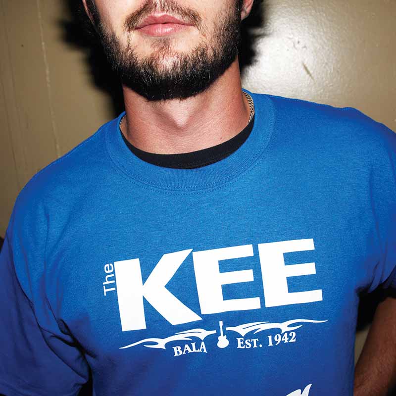 man wearing a blue KEE to Bala T-shirt