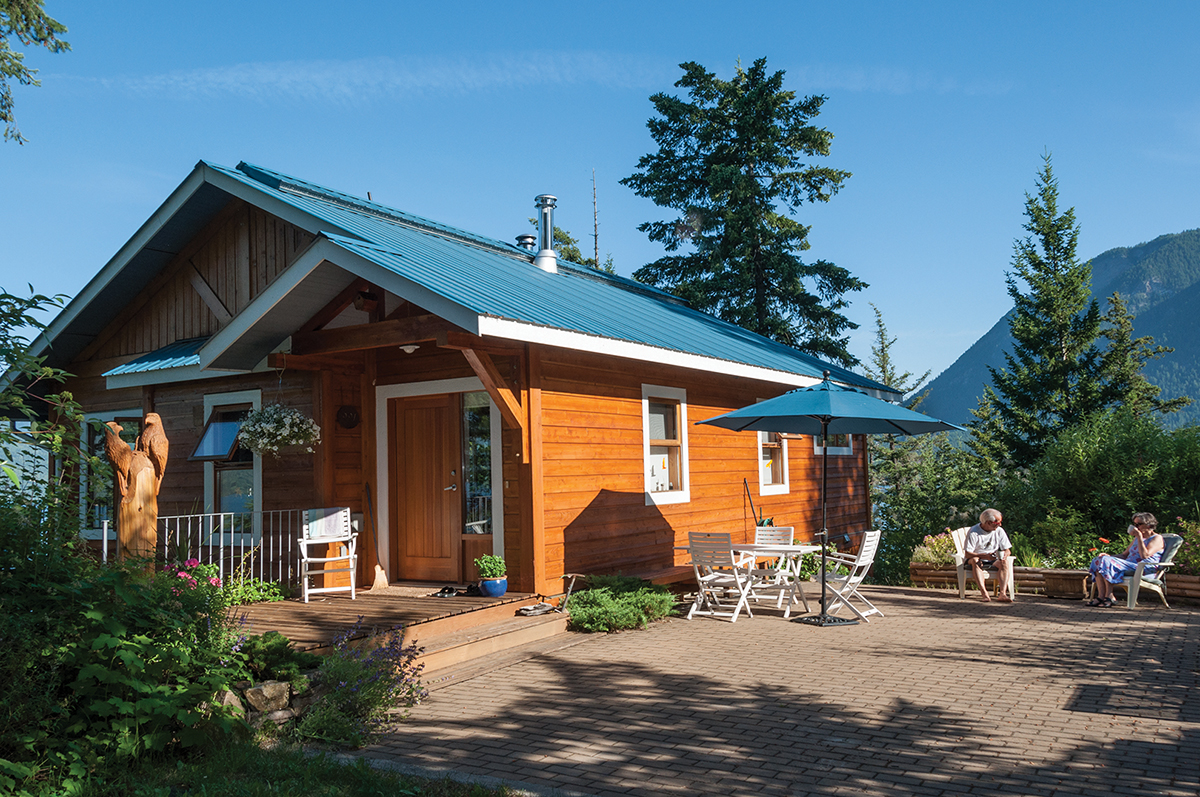 Exterior of the Vezzani cottage with green roof and orange cedar
