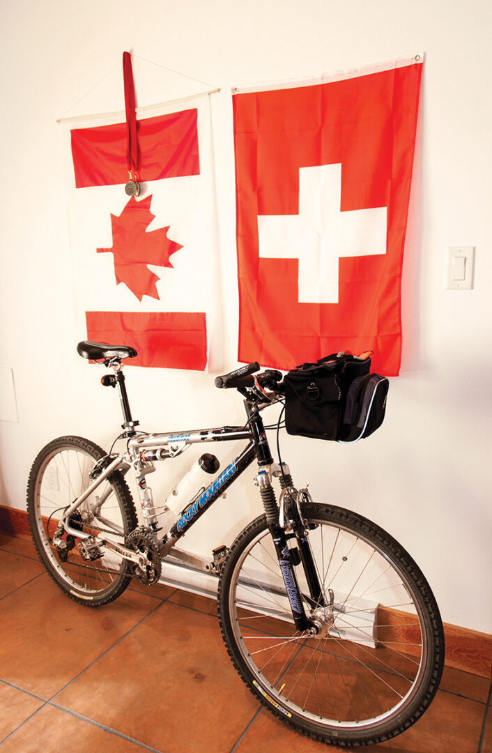 Piero's bike sits in front of a canadian and swiss flag