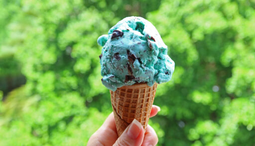 Close up of a hand holding a scoop of ice cream
