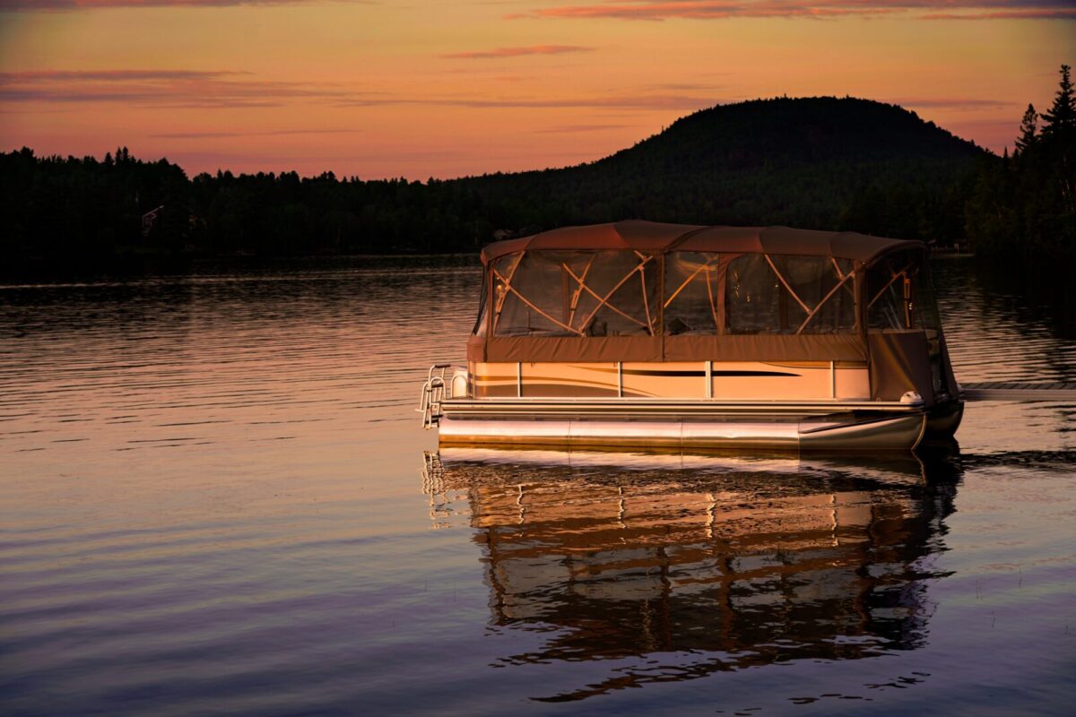 Pontoon boat on the lake at sunset