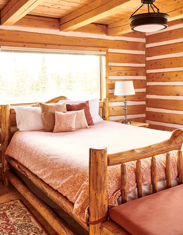 bed in a log-walled room