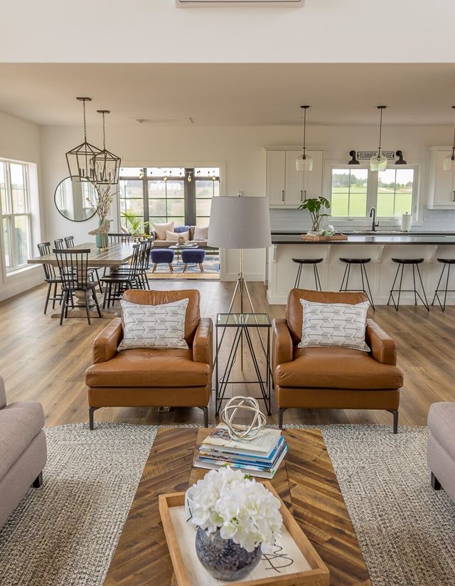 living room with red-brown chairs and kitchen in background