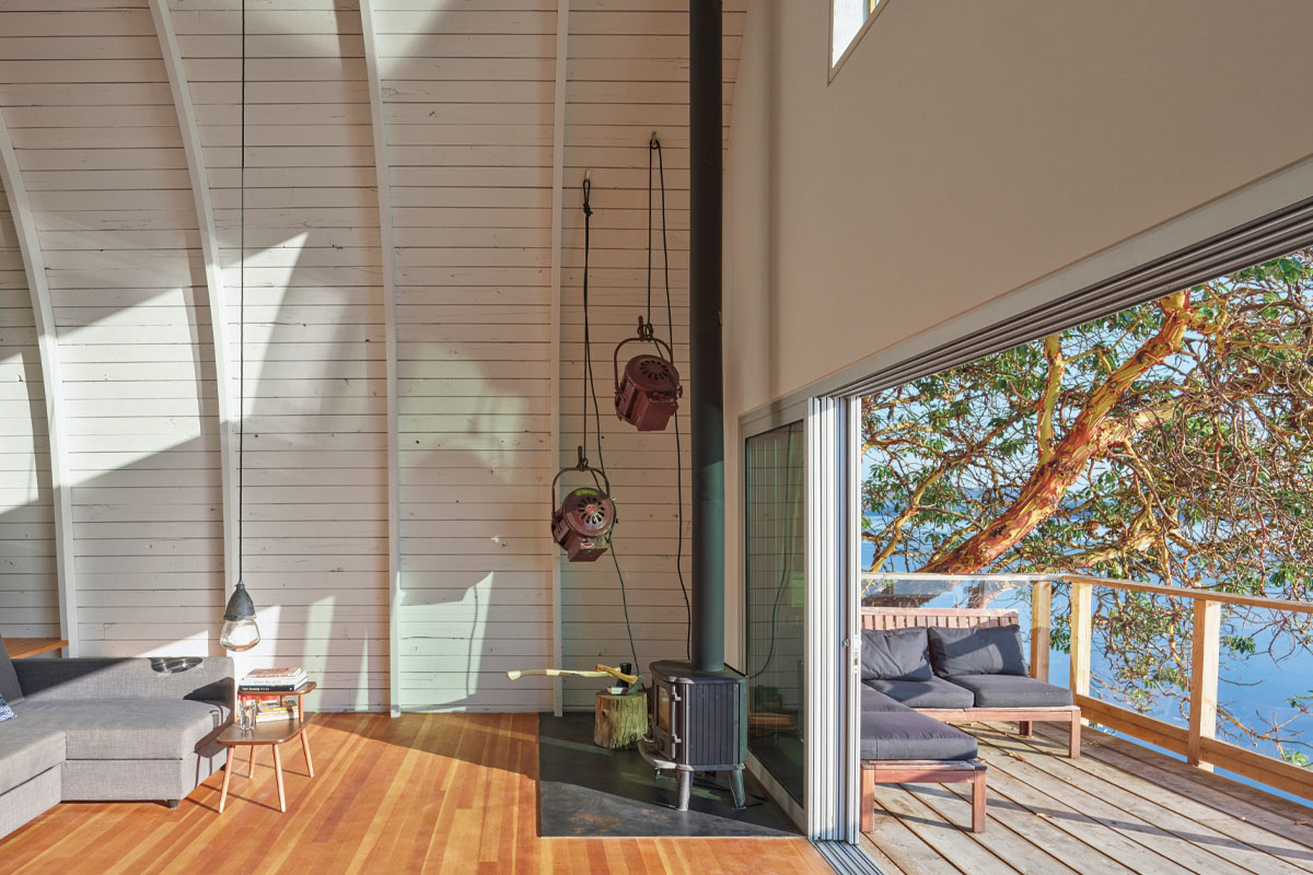A detail shot of the woodstove in the corner of the living room in the acorn cabin