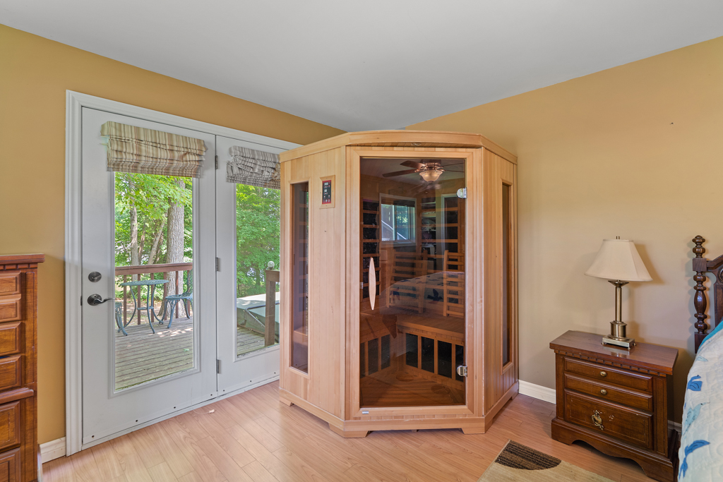 A small sauna built into the corner of a bedroom.