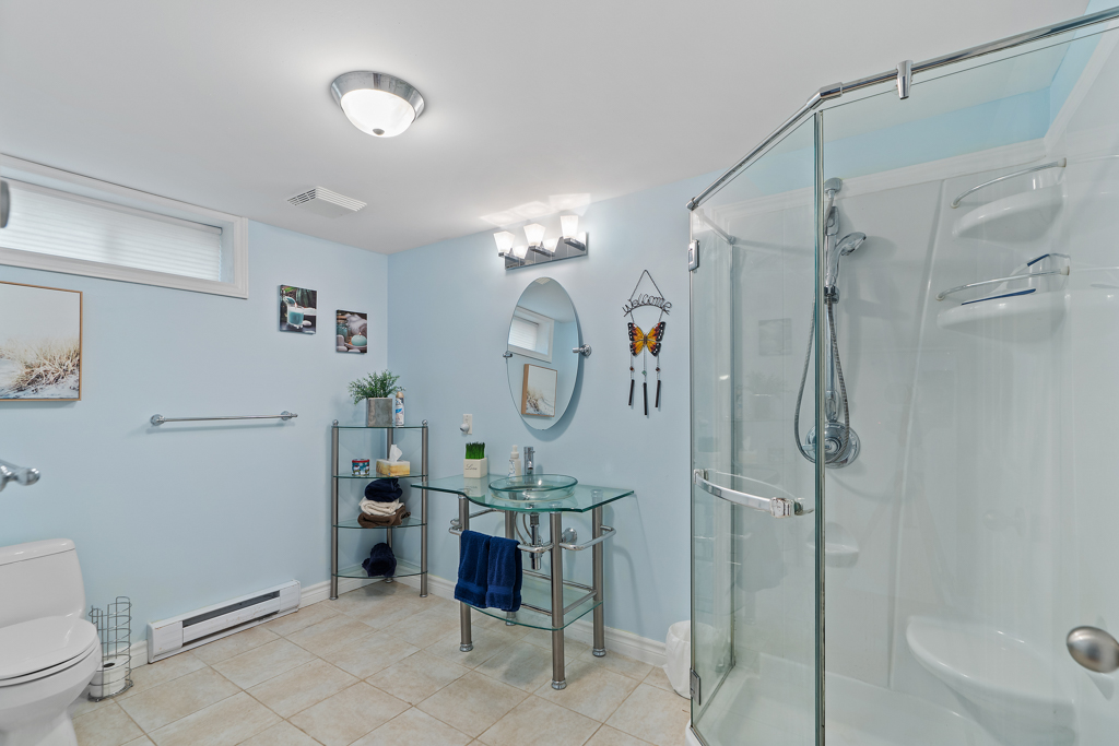 A big bathroom with a walk-in shower, a toilet, and a sink.