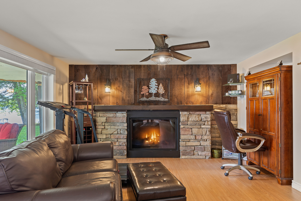A couch in front of a fireplace in a bright living space.