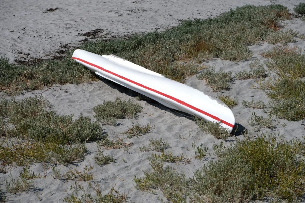 Overturned kayak on the shore of a beach