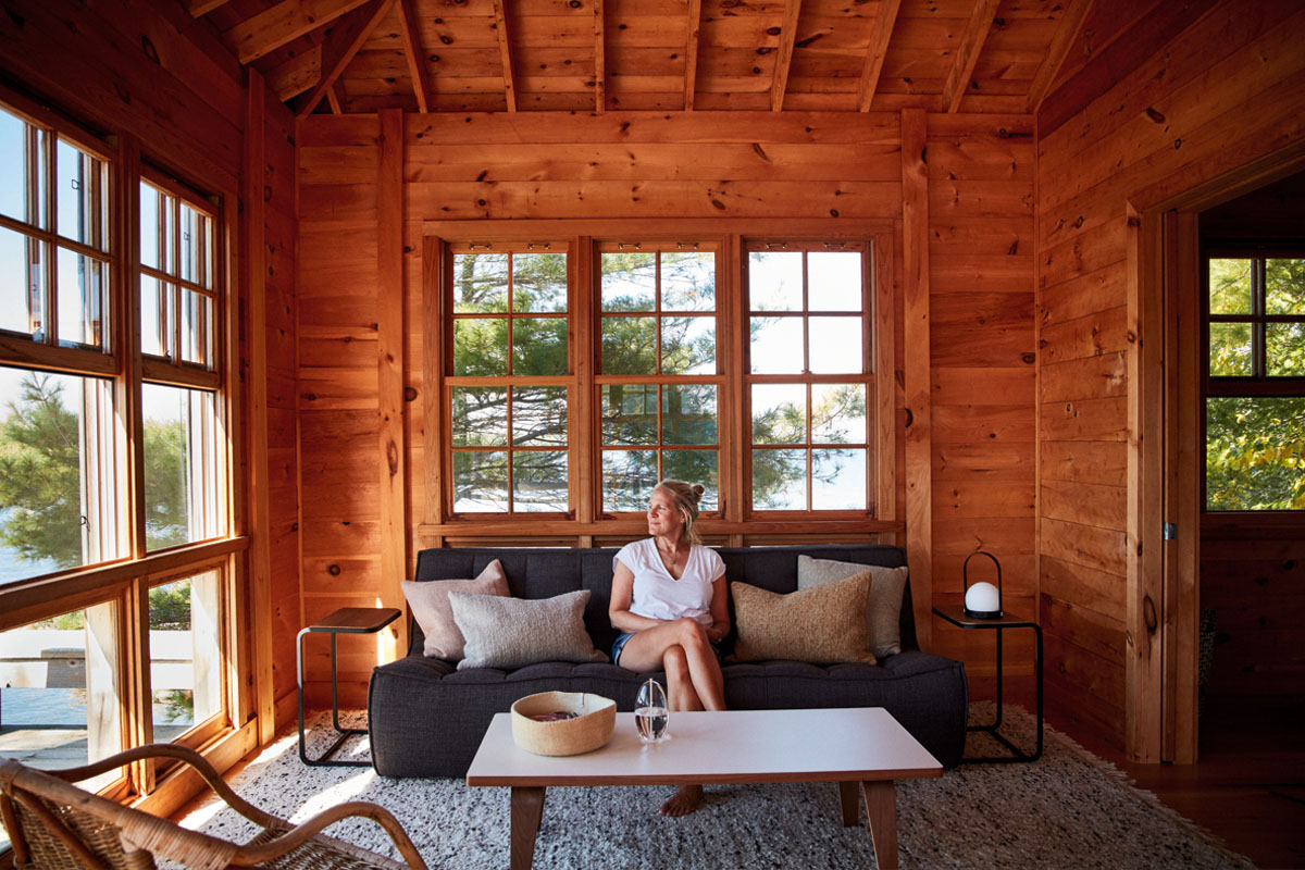 Artist Kara McIntosh sits inside the living room at her Georgian Bay cottage