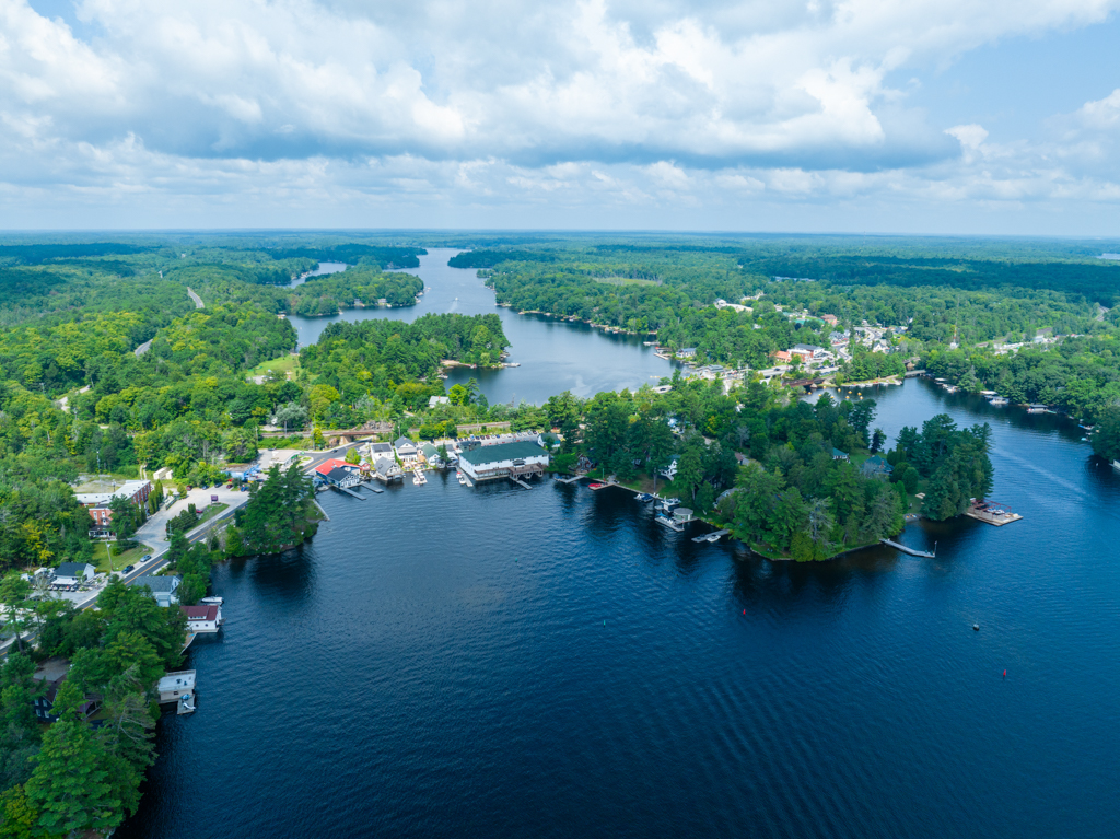 A road bridges two land formations across a lake.