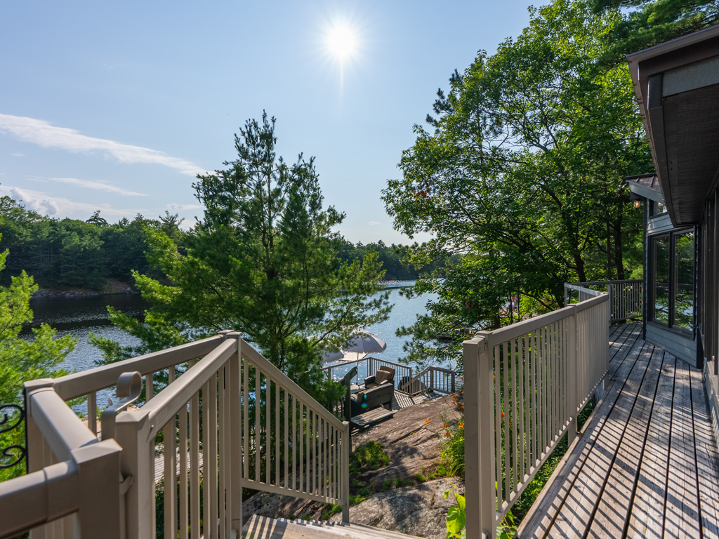 View from a deck with stairs leading down to the lake.