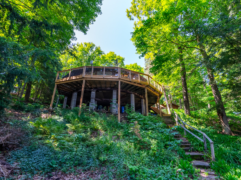 View up a long staircase leading to a big cottage.